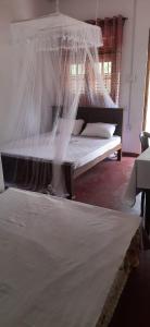 Postel nebo postele na pokoji v ubytování New Cinnamon Garden