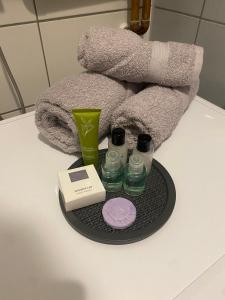 a tray with cosmetics and towels on a bathroom counter at APARTMENTS VRANAS Bjelašnica in Bjelašnica