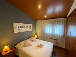 a bedroom with a white bed and a window at Ed. Euro Àtic in Encamp