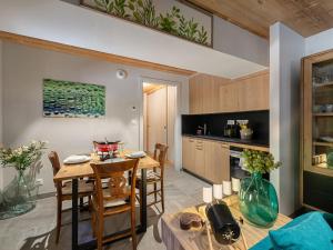 a kitchen and dining room with a table and chairs at Appartement Les Belleville, 2 pièces, 2 personnes - FR-1-570-16 in Praranger