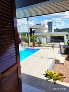 a view of a swimming pool from a house at Quartos familiares com piscina in Encantado