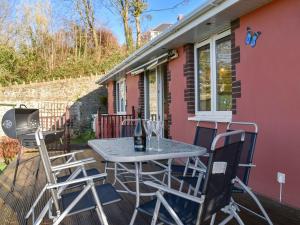 a patio with a table and chairs on a house at The Orchard in Bideford
