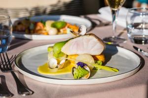 a table with two plates of food on a table at Atlantic Hôtel & Spa in Les Sables-d'Olonne