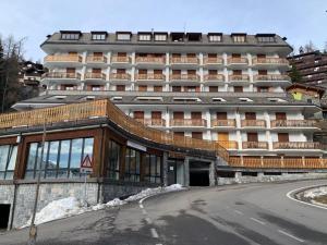 a large building in front of a building at Piccolo Rifugio di Foppolo in Foppolo