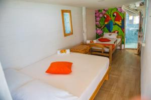 a room with two beds in it with a painting on the wall at Nuestros Tres Tesoros II in Playa Blanca