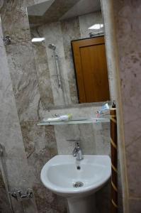 a bathroom with a sink and a mirror at Seymur’s house in Quba
