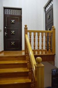 a set of stairs leading to a black door at Seymur’s house in Quba