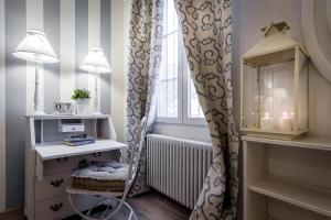 a room with a chair and a window with a radiator at Como Unique View - byMyHomeinComo in Como
