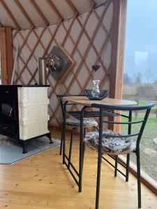 a table and a chair in a yurt at Yary Yurt in Všeruby