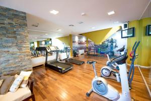 a gym with two treadmills and two exercise bikes at Los Silos Hotel in Santa Fe