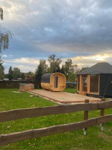a tiny house sitting on a deck in a field at Yary Yurt in Všeruby