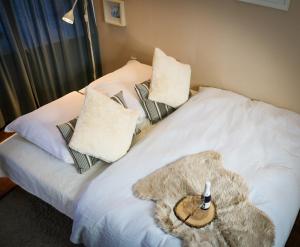 a bedroom with a white bed with a stuffed animal on it at Apartment Caroline - Gemütliche Ferienwohnung mit Pool, Sauna und Hochschwarzwaldcard in Schluchsee +13 photos