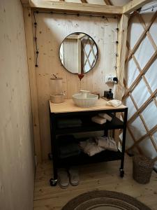a bathroom with a sink and a mirror in a igloo at Yary Yurt in Všeruby