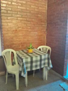 uma mesa com duas cadeiras e um vaso de plantas sobre ela em DEPARTAMENTO Alicia 2 em Santiago del Estero