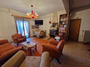 a living room with a couch and chairs and a table at Πανόραμα in Amfikleia