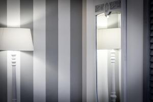 a room with two lamps and a mirror at Como Unique View - byMyHomeinComo in Como
