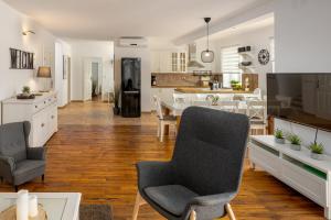 a kitchen and living room with a table and chairs at Villa Perla in Krk
