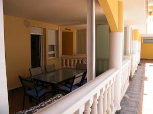 a balcony with a table and chairs on it at Apartamento frente al mar en Alcossebre in Alcossebre