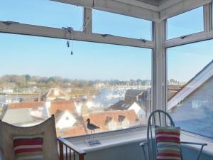 a window with a bird sitting on a roof at Bosuns Locker in Lymington