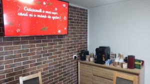 a brick wall with a sign on a wall at Pensiunea LUCA Straja in Straja