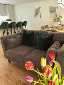 a living room with a couch and a table at Lux 2 Bedroom Ground Floor Apartment in Edinburgh