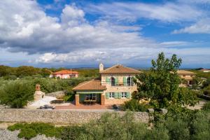 a large brick house with a roof at Villa Perla in Krk