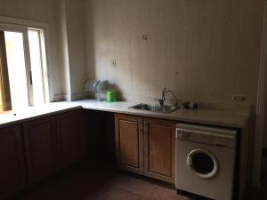 a kitchen with a sink and a washing machine at ڤيلا الميراچ Meriage in Cairo
