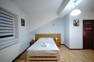 מיטה או מיטות בחדר ב-Apartament Lwowska