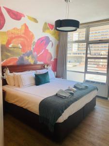 a bedroom with a large bed with a large window at Oceanic 2 Bedroom Apartment - City View - Self-Catering in Durban +31 photos