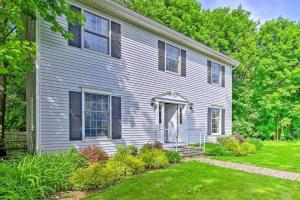 a white house with a porch and a yard at Walk to Dining Downtown Lenox Guest House! in Lenox