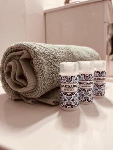 uma toalha e três copos num balcão na casa de banho em Paraíso a Dois em Estremoz em Estremoz