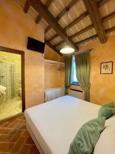 a bedroom with a large white bed and a window at Ca' Virginia Country House Wellness in Montecalvo in Foglia +103 photos