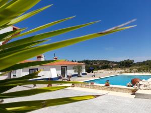 a view of a villa with a swimming pool at Monte das Rolas - A Serenidade mora Aqui! in Ferraria