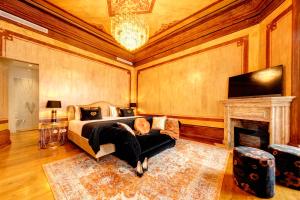 a bedroom with a bed and a fireplace and a tv at 1877 Estrela Palace in Aveiro