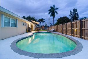 a swimming pool in the backyard of a house at Beachway Per ankh (House of Life) in Pompano Beach