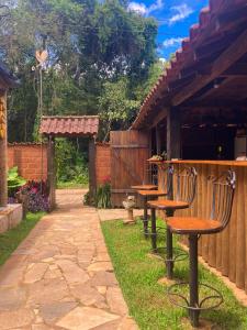 a patio with two chairs and a table at Casa de fadas in Tiradentes