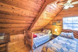 a bedroom with two beds in a log cabin at Cozy Tellico Plains Cabin with Large Mountain Creek! in Tellico Plains