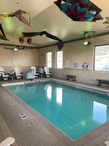 a large swimming pool with kites hanging from the ceiling at Boothill Inn and Suites in Billings