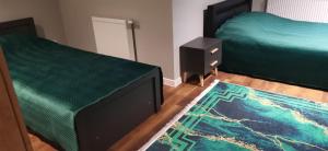 Postel nebo postele na pokoji v ubytování Apartamenty Green&Blue w Węgorzewie- GREEN