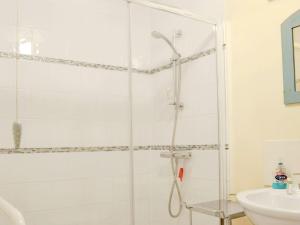 a shower with a glass door in a bathroom at The Wood Shed - E1919 in Westleton