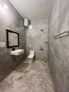 a bathroom with a sink and a toilet at Namaste Jungle - A Boutique Homestay in Assagao