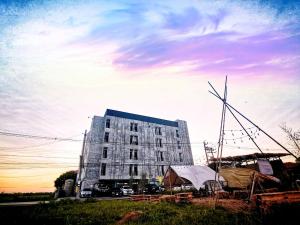 a large building with a windmill in front of it at Newman hotel in Ban Khlong Ha