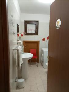 a bathroom with a white sink and a toilet at La villetta 2.0 in Rende