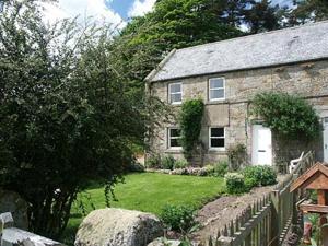 a stone house with a fence in front of it at Oak Cottage-16498 in Catcleugh