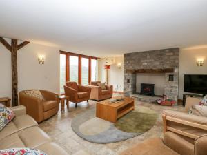 a living room filled with furniture and a fireplace at The Granary in Chepstow
