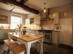 a kitchen with a wooden table and a stove at Manor House in York