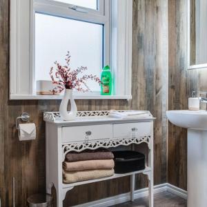 a bathroom with a white vanity with a window and a sink at Somerset House in Bangor +35 photos