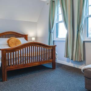 a bedroom with a crib with pillows and a window at Somerset House in Bangor