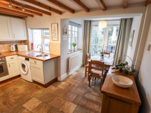 a kitchen with a sink and a table and a dining room at Thames Cottage in Hull