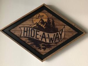 a sign that reads our hidden canyon hanging on a wall at Immaculate suite with amazing mountain views! in Cumberland